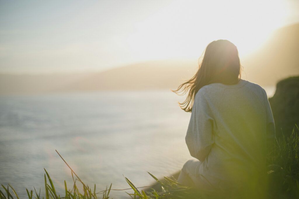 A women watching a sunset from a beautiful scenery.