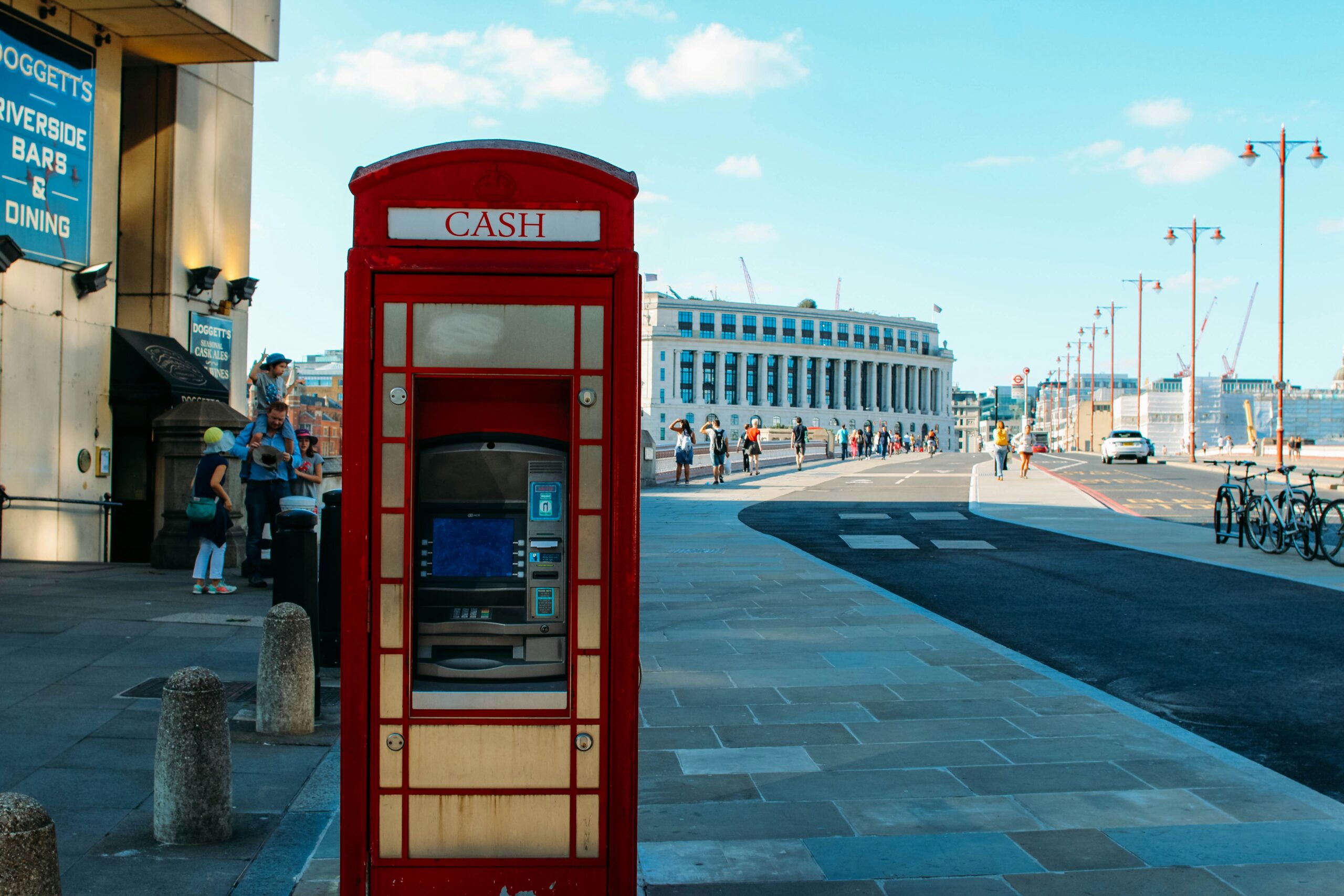 Cash sign on the red telephone box.