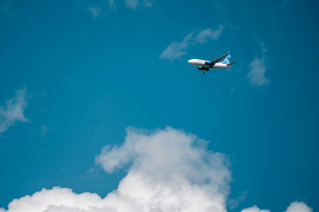 Airplane flying in the blue sky.